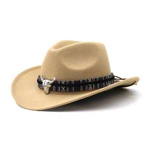 Macro detail of khaki cowboy hat with ethnic braided band and silver bull skull ornament