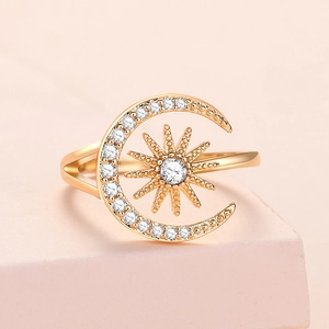 Adjustable gold sun and moon ring featuring micro-pave cubic zirconia on a pink pedestal