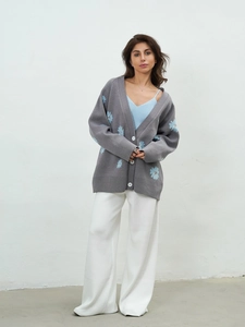 Loose knit gray cardigan with blue daisy embroidery and V-neckline in relaxed fit style