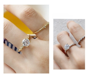 Macro shot of 925 sterling silver four-prong round zircon rings in gold and silver finish