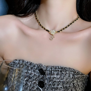 Elegant gold metal and black leather woven necklace with white camellia and number 5 charm