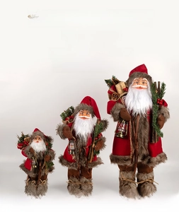 Three assorted standing Santa Claus figurines with rustic lanterns and gift bags