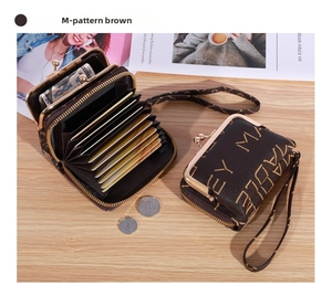 Detail of brown faux leather wallet showing accordion card slots and metal clasp