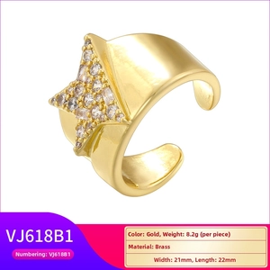 Macro shot of gold star-shaped brass ring with crystal pavé and adjustable U-shaped band