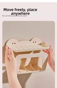 Detail of cream-colored wall-mounted tissue holder with cute bear ear design and dual-tier