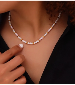 Detailed shot of bohemian beaded necklace with white pearls and marble stone accents
