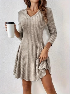 Close-up of gray V-neck knitted dress featuring soft ribbed texture and slim-fit long sleeves