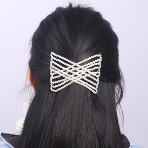 Elegant pearl hair comb with criss-cross bead pattern shown on a model hair