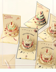 Detail of 3D pop-up birthday card featuring a multi-layered cake and strawberry accents