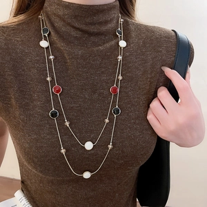 Détail du collier pull double couche avec breloques en émail tricolore et cristaux
