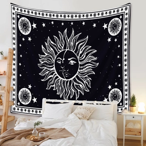 Bedroom wall scene featuring a black and white celestial sun and moon tapestry art