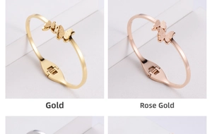 Detailed macro of gold and rose gold titanium butterfly bangles with spring clasp