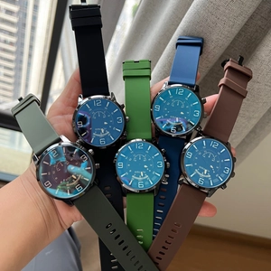 Close-up of diverse quartz watches with blue dials and colorful silicone straps