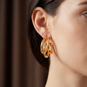 Minimalist gold multi-layered C-shaped hoop earrings with a polished metallic finish