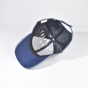 Interior detail of a blue denim baseball cap showing sweatband and reinforced structure