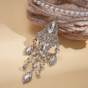 Macro detail of multi-layer fringe pendant with crystals and pearls on silver choker