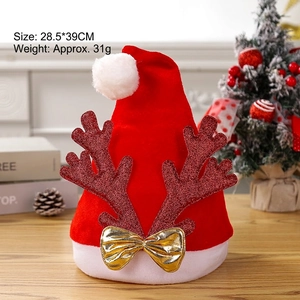 Red velvet Christmas hat with glittery reindeer antlers and a golden bow decoration