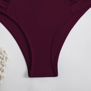 Detail view of burgundy bikini bottom showing double-needle stitching and fabric texture