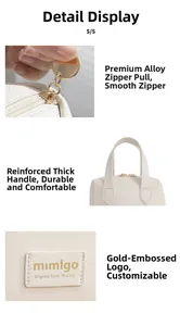 Detail of cream PU shell bag showing gold alloy zipper and reinforced handle design