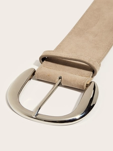Close-up of beige suede leather belt with polished silver D-ring metal buckle