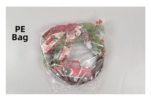 Close-up of a Christmas truck wreath with PE pine needles and red berries in polybag