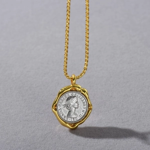 Macro detail of 18k gold plated vintage coin pendant featuring Queen Elizabeth II portrait