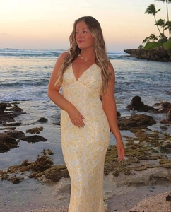 Detailed close-up of delicate lace embroidery on a slim fit V-neck evening maxi dress