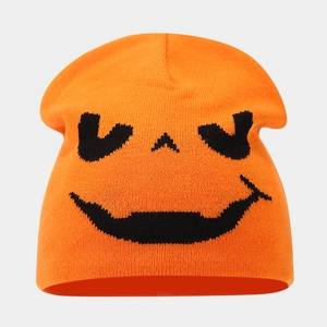 Macro view of high-quality orange knitted fabric and black pumpkin pattern embroidery