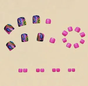 Detail of pink bohemian style press-on toenails with paisley and sunflower patterns