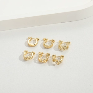 Set of 6 gold minimalist U-shaped ear cuffs with zircon stones on white background