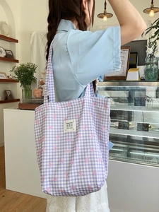 Purple plaid canvas tote bag with pink bow prints for students on a blue strap