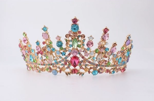 Detail view of ornate gold bridal tiara with colorful crystal rhinestones and gems