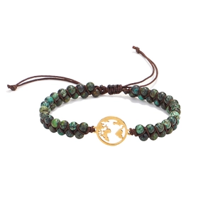 Close-up of African turquoise beads with a golden world map charm on braided cord