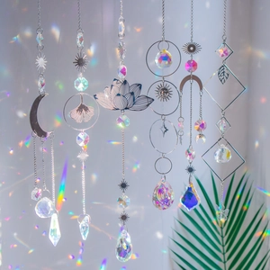 Lotus moon and sun crystal prism suncatchers reflecting rainbow light on a clean background