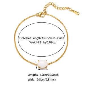 Detail view of gold stainless steel bracelet with white oval stone and size measurements
