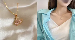 Detail of golden swan pendant with pink marquise crystals and white stone accents