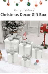 Set of five white Christmas gift boxes with silver glitter bows in a festive snow scene