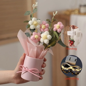 Detail of pink knitted flower puff bucket bouquet with LED string light and handbag