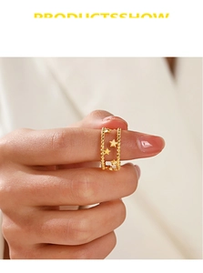 Detail of 18K gold-plated double-layer open star ring with delicate bead chain and charms
