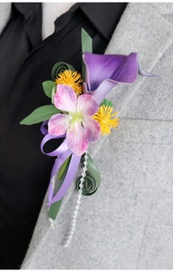 Detail of a purple Calla Lily and Orchid boutonniere on a grey suit lapel for weddings