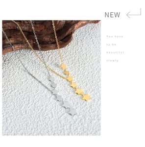 Detail of star tassel necklace with multiple stars in gold and silver finish