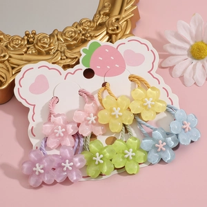 Set of 10 colorful flower hair ties for girls on strawberry card display closeup