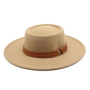 Detail of camel wool felt boater hat with brown leather strap and silver rivet accents