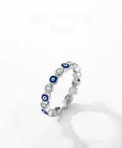 Macro shot of S925 silver ring featuring blue evil eye charms and round zircon stones