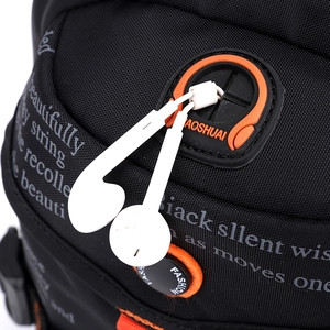 Detail of black tactical waist bag with orange earphone port and printed text
