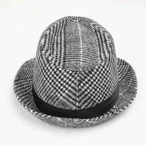 Close-up of black and white houndstooth fedora hat with a black grosgrain ribbon band