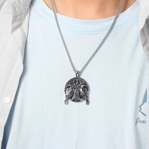 Detailed view of a silver Viking crow pendant featuring the Tree of Life on a necklace