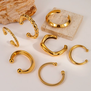 Minimalist gold stainless steel open bangles in various textures and geometric designs