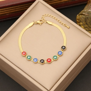 Golden snake chain bracelet featuring colorful evil eye beads on a jewelry box
