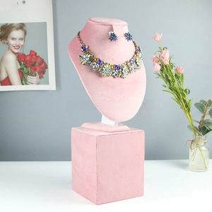 Pink velvet bust stand for jewelry display with necklace and matching earrings